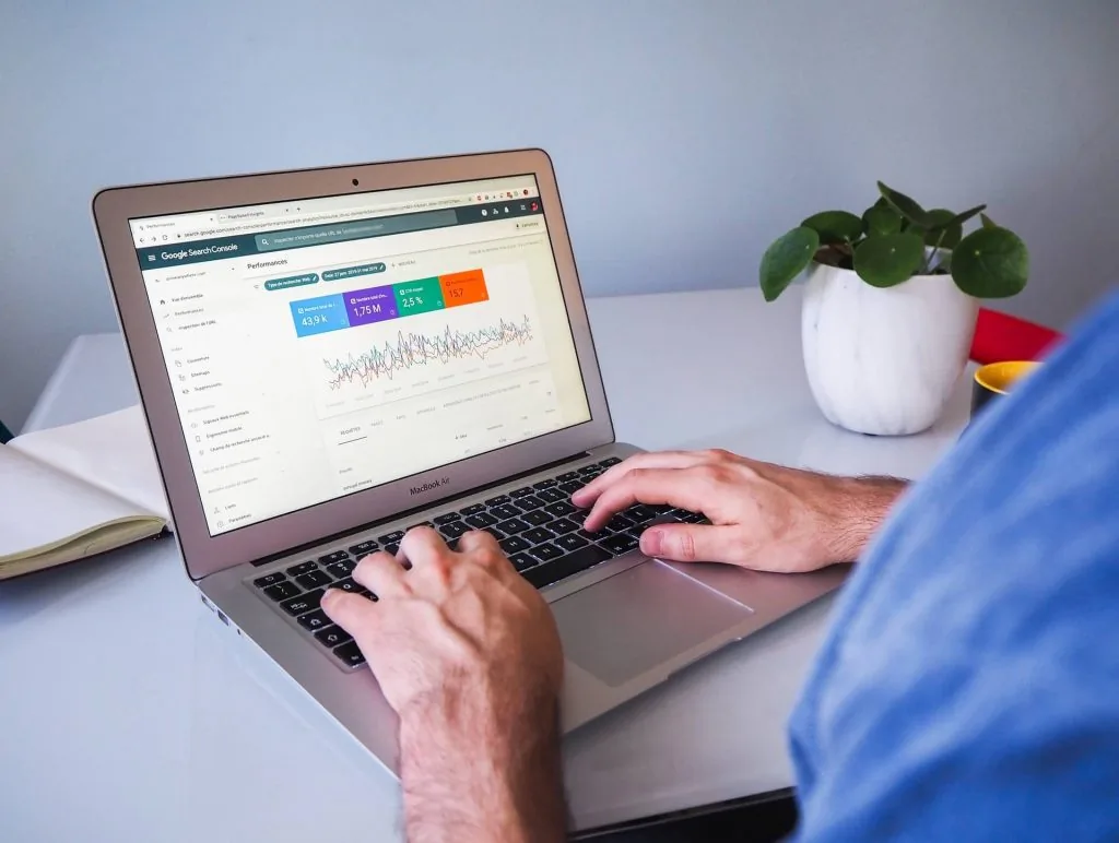 Marketer analysing an SEO dashboard on a laptop